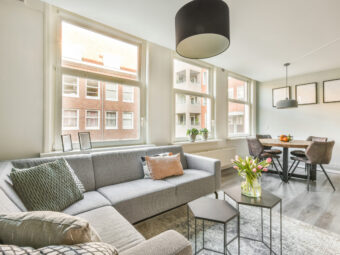 Spacious attic room with sofa and kitchen
